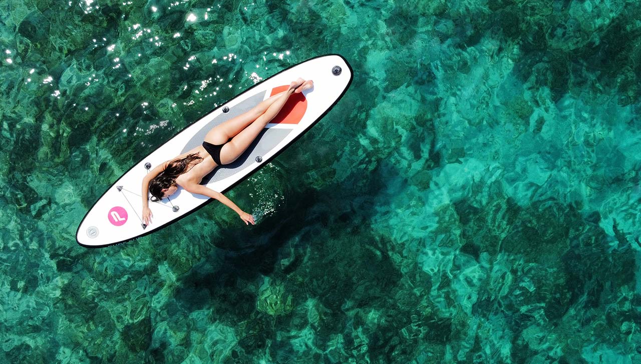 Drone photography SUP surfer girl on turquoise tropical waters